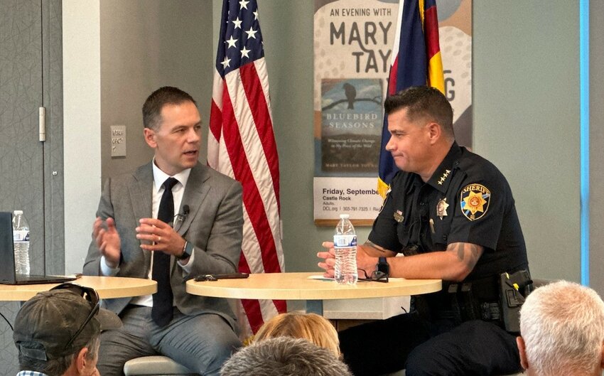 18th Judicial District Attorney John Kellner on the left and Douglas County Sheriff Weekly on the right discuss courtroom and crime updates in Douglas County during a town hall on Aug. 2, 2023, at the Highlands Ranch Library.